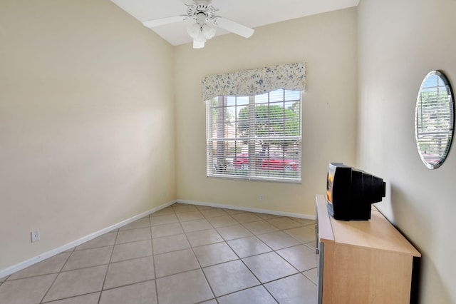 tiled empty room with ceiling fan