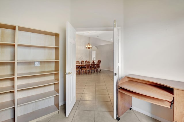 hall featuring an inviting chandelier and tile patterned floors