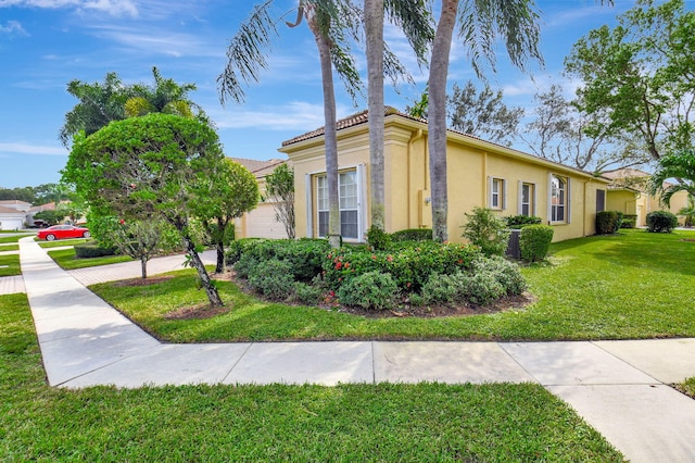 view of side of home with a yard