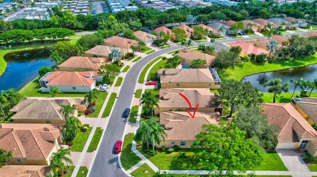 birds eye view of property with a water view