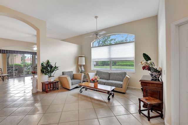 tiled living room with ceiling fan and a wealth of natural light