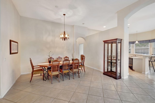 tiled dining area with wine cooler, a chandelier, and sink