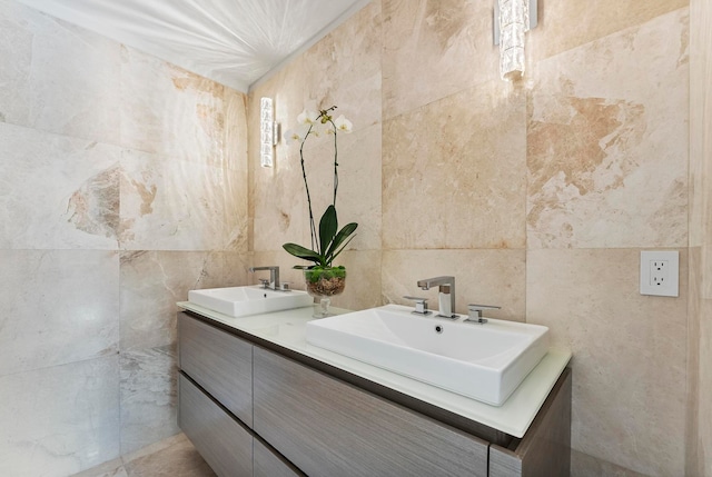 bathroom featuring vanity and tile walls