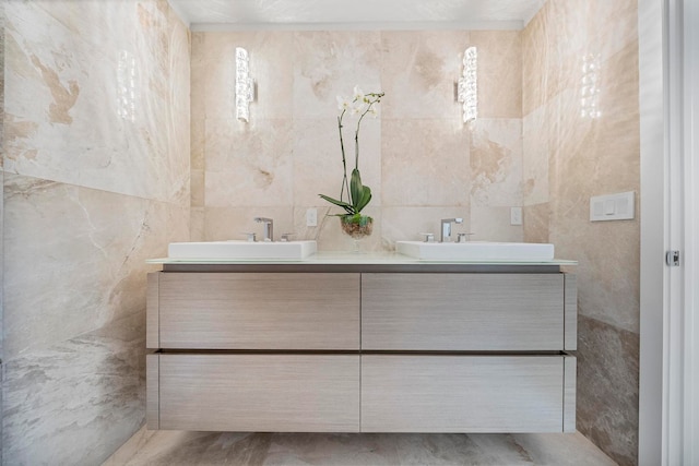 bathroom with vanity and tile walls