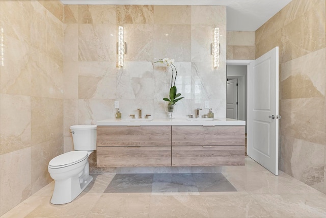 bathroom featuring vanity, toilet, and tile walls