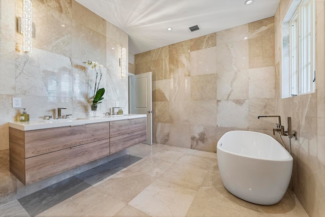 bathroom featuring vanity and tile walls