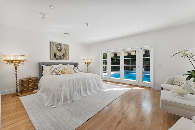 bedroom with access to exterior, french doors, and light hardwood / wood-style flooring