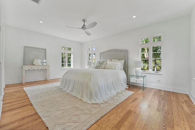 bedroom with light hardwood / wood-style floors and ceiling fan