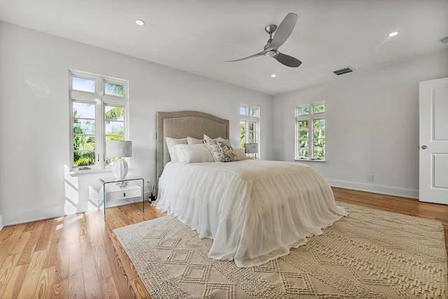 bedroom with ceiling fan and light hardwood / wood-style floors