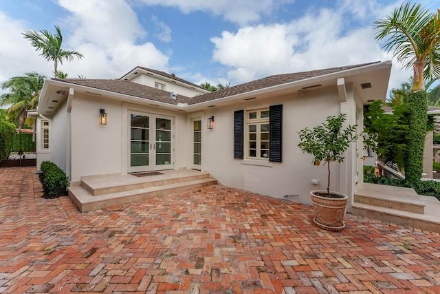 rear view of property with french doors and a patio