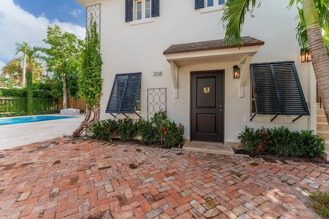 doorway to property featuring a fenced in pool