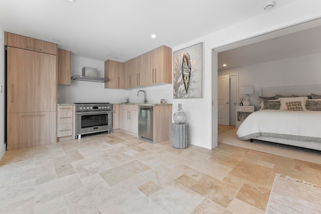 kitchen featuring sink, stainless steel appliances, and wall chimney range hood