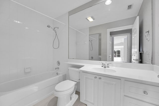 full bathroom with vanity, tiled shower / bath combo, toilet, and tile patterned floors