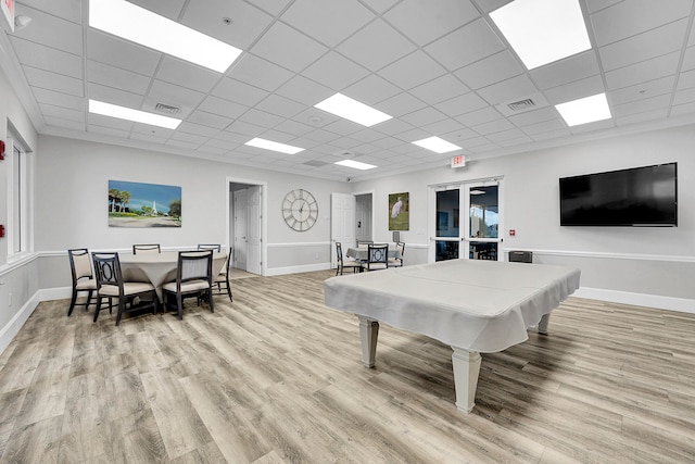 recreation room featuring a drop ceiling, pool table, light hardwood / wood-style floors, and french doors