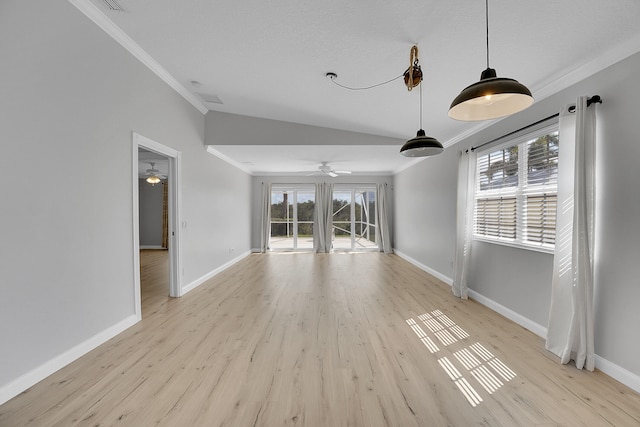 unfurnished living room with light hardwood / wood-style floors, crown molding, and vaulted ceiling