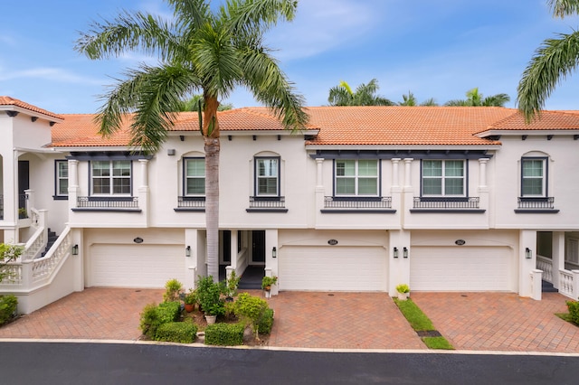 mediterranean / spanish-style home with a garage