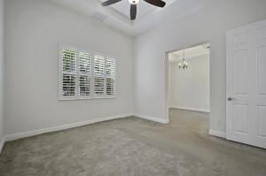 empty room featuring ceiling fan, baseboards, a tray ceiling, and carpet flooring