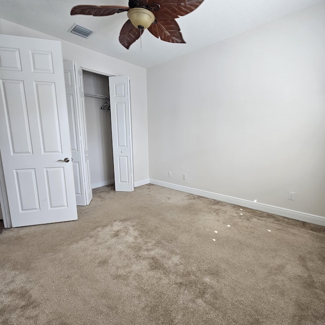 unfurnished bedroom featuring carpet, a closet, visible vents, a ceiling fan, and baseboards