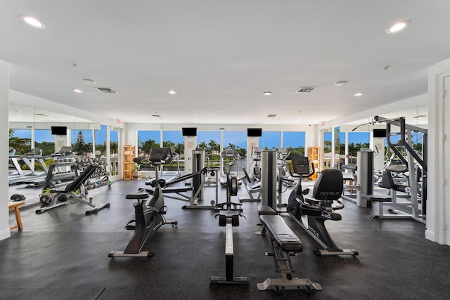 gym featuring visible vents, a wealth of natural light, and recessed lighting