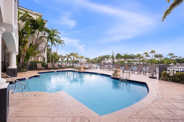 community pool featuring a patio area and fence