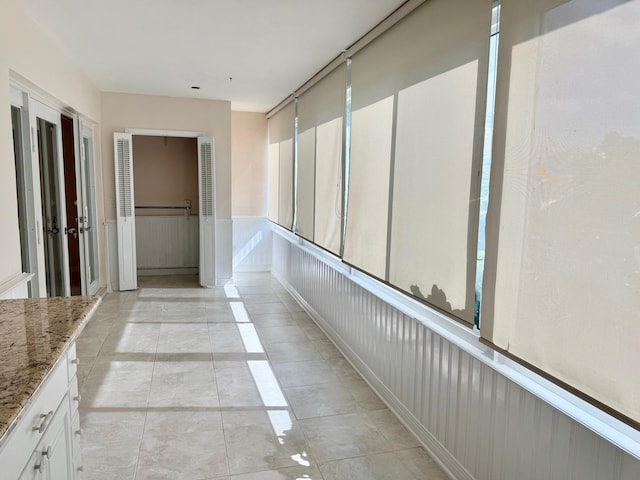 corridor featuring light tile patterned floors