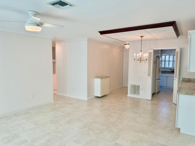 unfurnished room featuring ornamental molding and ceiling fan with notable chandelier