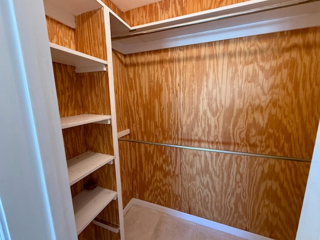 spacious closet with light tile patterned floors