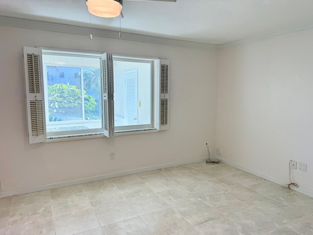 empty room featuring ornamental molding and light tile patterned flooring