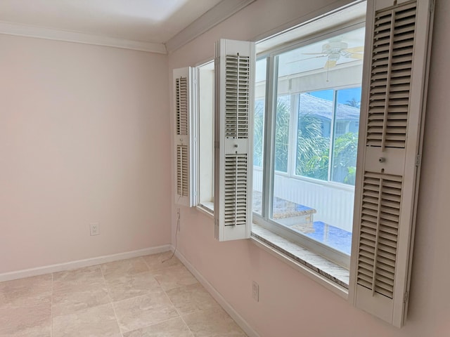 empty room with ceiling fan and crown molding