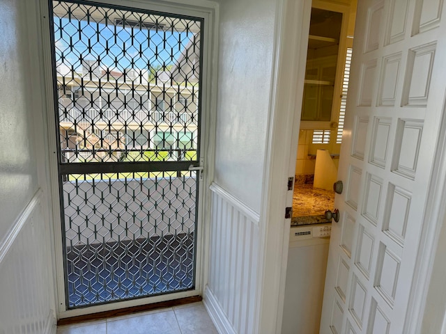 doorway to outside featuring light tile patterned floors