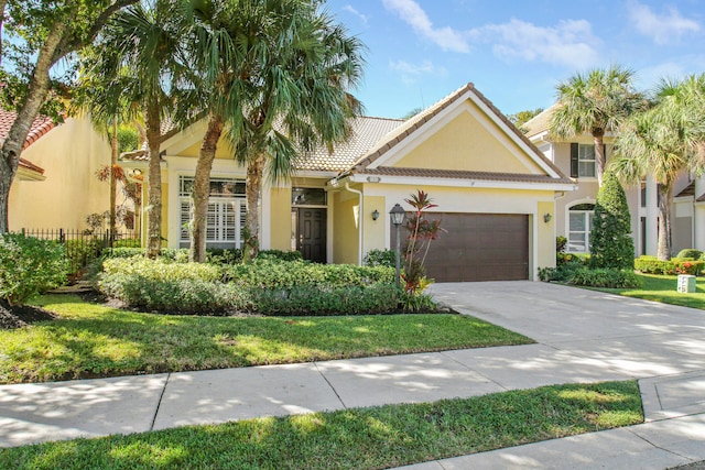 mediterranean / spanish-style house featuring a garage