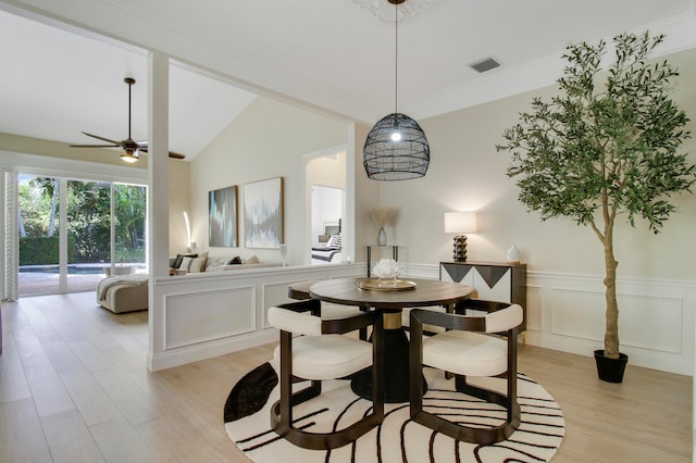 dining room with ceiling fan, lofted ceiling, and light wood-type flooring