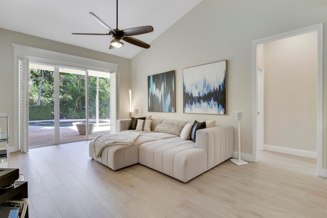 living room featuring light hardwood / wood-style floors, high vaulted ceiling, and ceiling fan