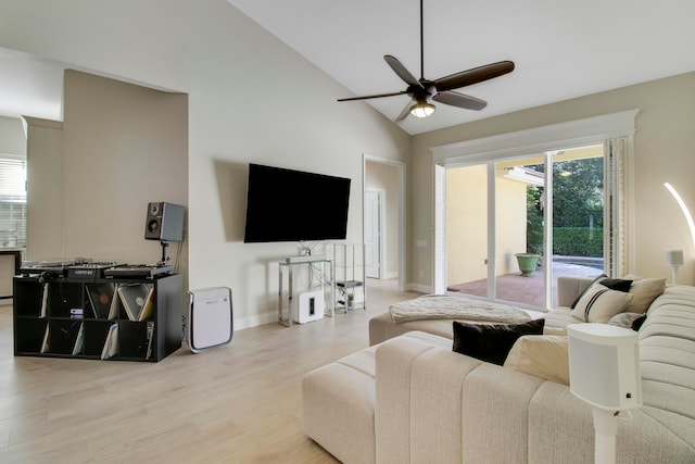 living room with vaulted ceiling, light hardwood / wood-style flooring, and ceiling fan