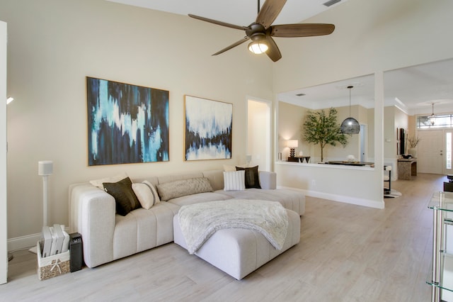 living room with ceiling fan and light hardwood / wood-style flooring