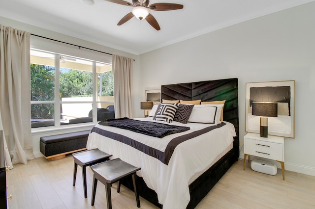 bedroom featuring ornamental molding, light hardwood / wood-style flooring, and ceiling fan