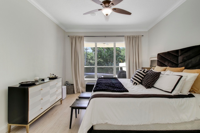 bedroom featuring ornamental molding, light wood-type flooring, and ceiling fan