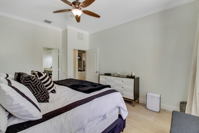 bedroom featuring ceiling fan, ornamental molding, and light hardwood / wood-style flooring