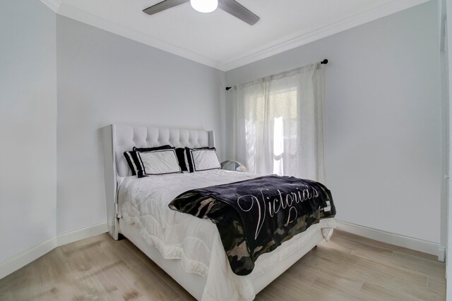 bedroom featuring crown molding, wood-type flooring, and ceiling fan