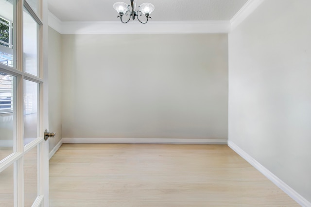 unfurnished room with ornamental molding, a chandelier, and light hardwood / wood-style floors