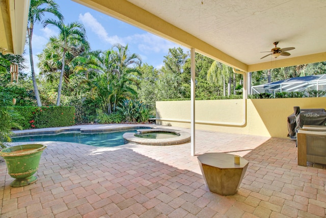 view of pool with an in ground hot tub, ceiling fan, grilling area, and a patio area