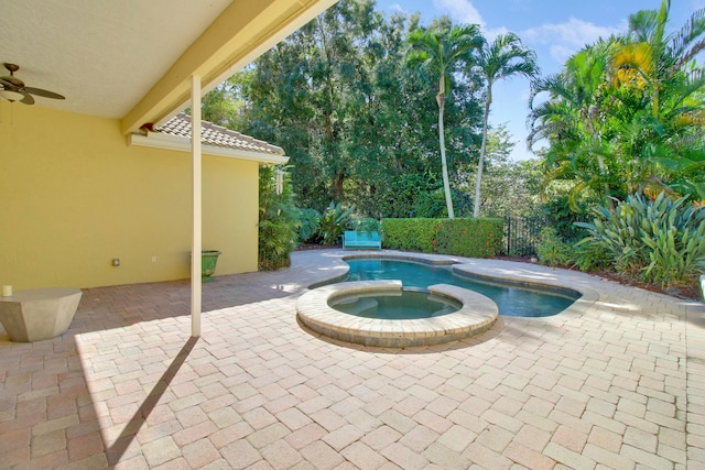 view of swimming pool with an in ground hot tub, a patio area, and ceiling fan