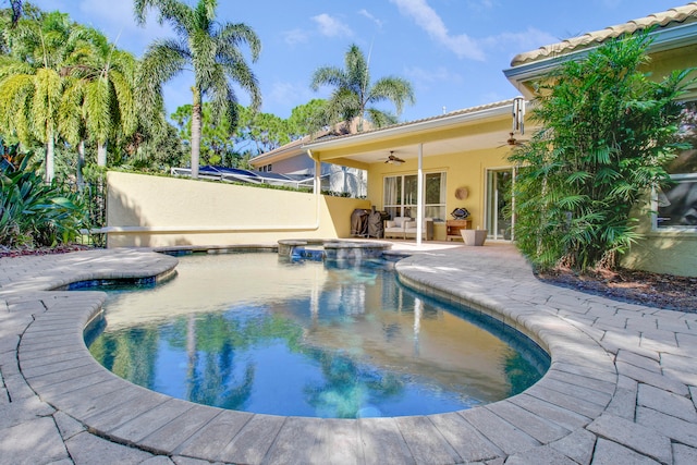 view of swimming pool featuring a patio area, an in ground hot tub, and ceiling fan