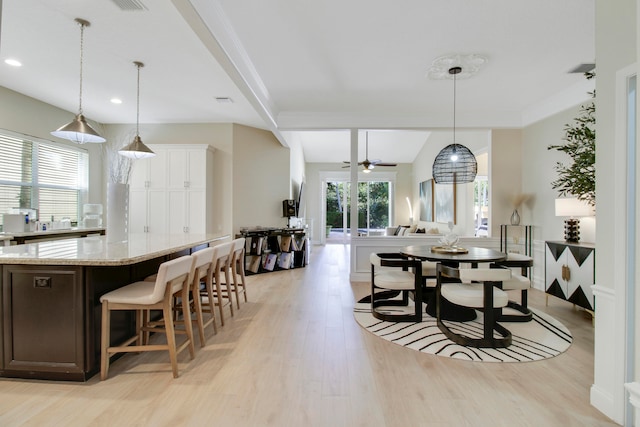 dining space featuring ceiling fan and light hardwood / wood-style flooring