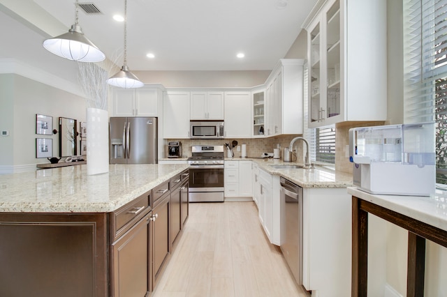 kitchen with sink, white cabinets, and stainless steel appliances