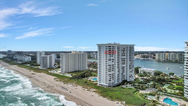 birds eye view of property with a water view, a beach view, and a city view