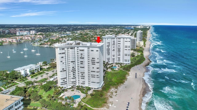 aerial view featuring a view of the beach, a water view, and a city view