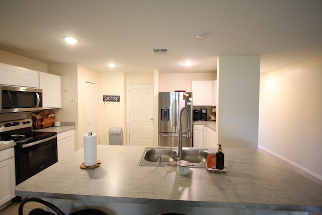 kitchen featuring white cabinetry, stainless steel appliances, and sink