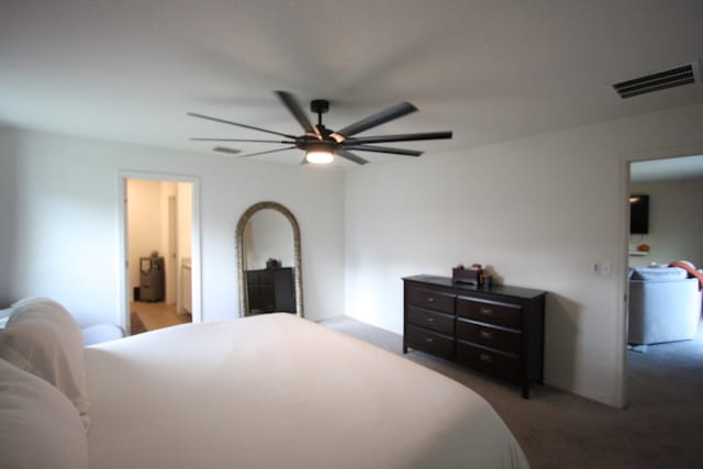 bedroom featuring ceiling fan and dark carpet