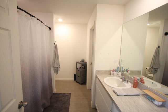 bathroom featuring vanity and toilet